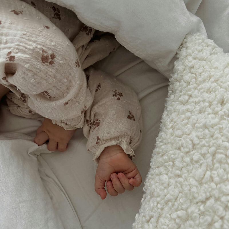 close up of baby hands for article on top baby names in america
